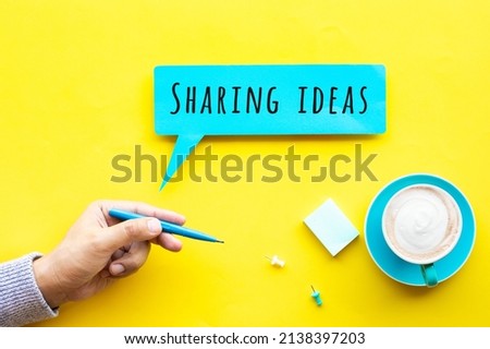 Sharing ideas with person hand holding pen with text.inspiration or creativity.top view