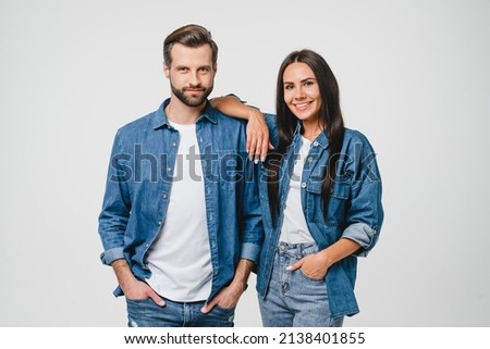 Successful confident young caucasian couple spouses girlfriend and boyfriend looking at camera wearing denim jeans clothes isolated in white background. Love and relationship. Bonding Royalty-Free Stock Photo #2138401855
