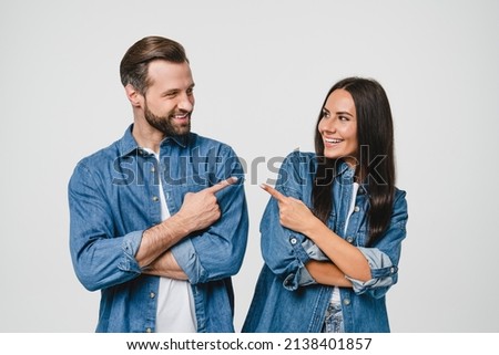 Smiling loving young couple boyfriend and girlfriend spouses wife and husband pointing at each other, showing with fingers, choosing selecting accusing isolated in white background Royalty-Free Stock Photo #2138401857