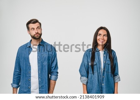 Thoughtful pensive caucasian young couple spouses boyfriend and girlfriend looking upwards for copyspace, idea, think, creativity isolated in white background. Sale discount Royalty-Free Stock Photo #2138401909