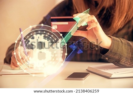 Multi exposure of woman on-line shopping holding a credit card and crypto theme drawing. Blockchain E-commerce concept.