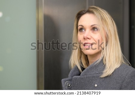 Woman with shoulder length blond hair looking up with an interested intrigued expression and parted lips in close up Royalty-Free Stock Photo #2138407919