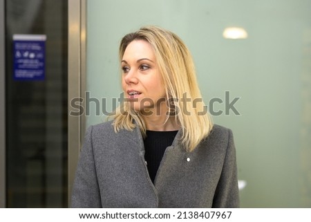 Woman with shoulder length blond hair looking to side with an interested intrigued expression and parted lips in close up Royalty-Free Stock Photo #2138407967