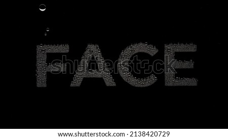 Word face printed on the wet glass on black background | face moisturizer ad