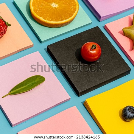 Colorful minimalist mosaic photo of fruit on square sticky notes tiles, bright flatly of baby tomato, orange, lemon, blueberry, cranberry, strawberry, star fruit, mango and grape tic tac toe