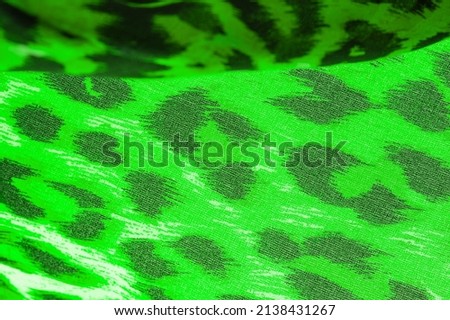 Silk fabric with leopard print. Green and white. Enjoy the jungle vibe with this khaki and black cheetah print silk chiffon Thrilling to the wild side the spotted image of the cheetah pushes forward