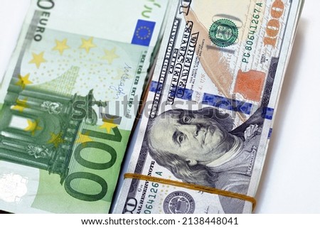 Pile of American money banknote bills with European cash money banknotes, stacks of USA dollars, 100 $ one hundred dollars and €100 one hundred Euros papers exchange rate isolated on white background Royalty-Free Stock Photo #2138448041