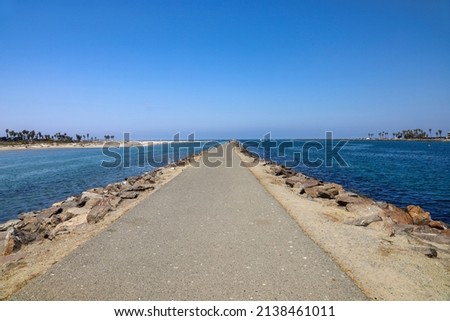 The long Quivira jetty in San Diego, California across from dog beach.