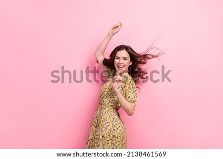 Portrait of cheerful pretty person flying hairdo good mood clubbing free time isolated on pink color background