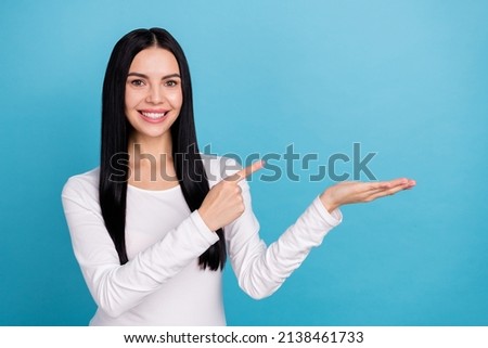 Photo of impressed brunette millennial lady hold index promo wear outfit isolated on blue color background