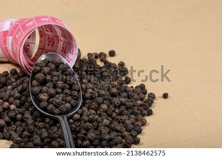 black pepper, a bottle of oil and a tape measure