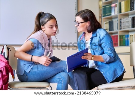 Woman school psychologist teacher talking and helping student, girl teenager Royalty-Free Stock Photo #2138465079