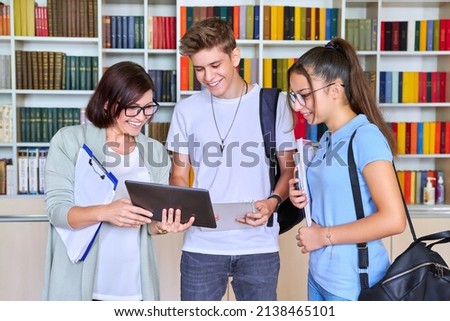 Students teenagers talking with woman teacher mentor Royalty-Free Stock Photo #2138465101