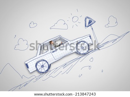 Young man driving car made of sheet of paper