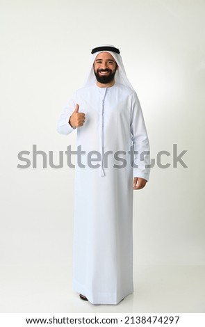 Happy Emirati man thumbs up in UAE enjoying achieving success making OK sign isolated on white background