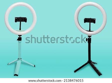 Selfie ring lamp with tripod on a blue background