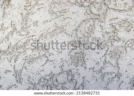 Embossed wall texture. Background, plaster, scratches, texture, gray color.