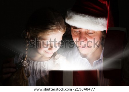 Happy daughter getting Christmas present from father