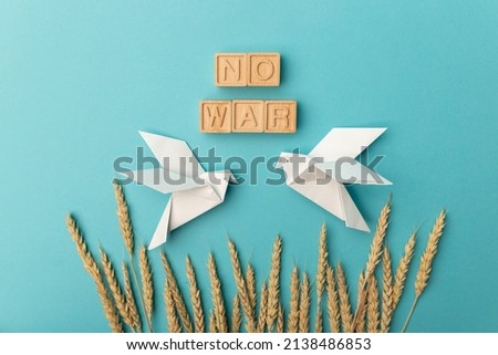 Ears of wheat and letters No war on a blue background. There is no war. Stop the war.