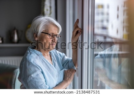 Senior woman looking out of window at home
 Royalty-Free Stock Photo #2138487531