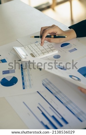Businessman's hands are analyzing charts, graphs, financial data. and accounting documents The displayed data calculates the planning strategy. vertical photo business success process