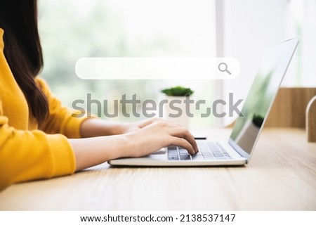 Woman using computer laptop on wood desk. She working at home