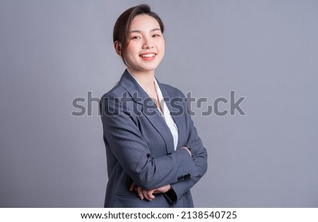 Portrait of a beautiful Asian businesswoman on a gray background
 Royalty-Free Stock Photo #2138540725
