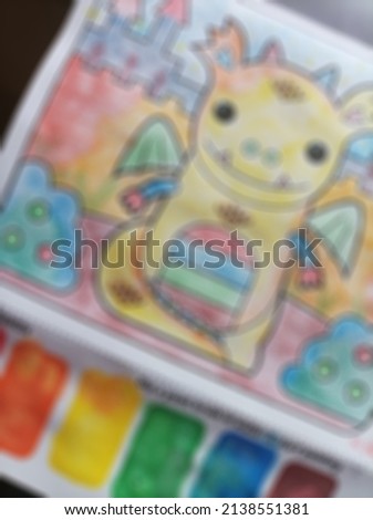 Defocused or blur picture of a dragon image on children painting book