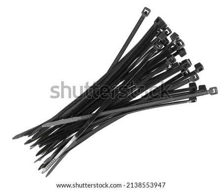 Black plastic cable ties isolated on white background. plastic wire ties closeup. Royalty-Free Stock Photo #2138553947