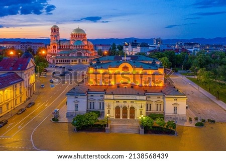 Night view of the National Assembly of the Republic of Bulgaria and Alexander Nevski cathedral in Sofia. Sign translates - Unity makes power