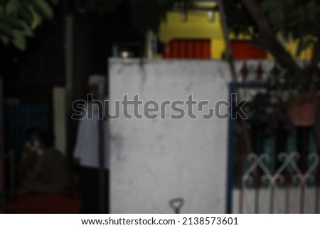 defocused abstract white wall in front yard at night