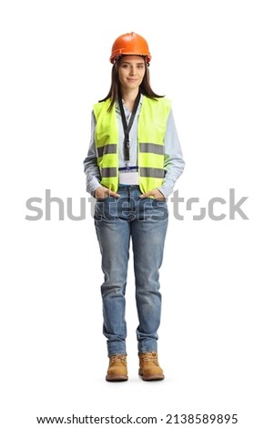 Full length portrait of a young female site engineer with a safety vest and hardhat isolated on white background Royalty-Free Stock Photo #2138589895