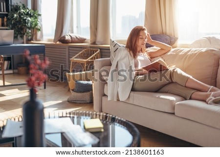 Reading literature. Woman at home with a book