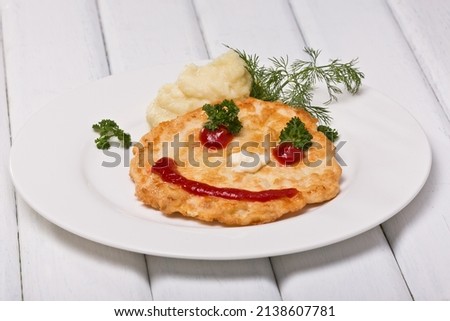 Children's cutlet, emoticon. Photo of food on a white background