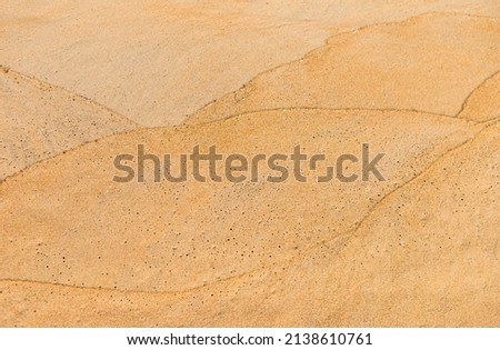 Wave pattern on sand beach, blank brown sand texture background
