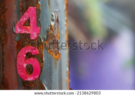 Number 4 6 pink from the sticker that was pasted peeling off with paint around                               