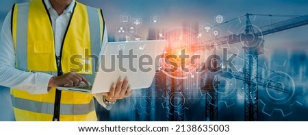 Double exposure engineering working with digital technology interfaces icon and construction cranes on city background, Smart industry and digital technology and IOT software concept. Royalty-Free Stock Photo #2138635003