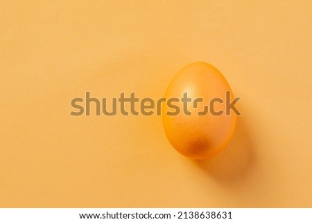 one yellow egg on a yellow background