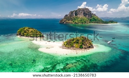 Thale Waek Island in Krabi Thailand with white sand beaches and tropical turquoise blue water surrounded by coral reefs and Ko Poda Island in the distance