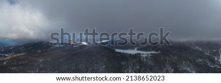 Virtual reality panorama at 180 degrees of the winter of the Nebrodi mountains. Snow-covered and frozen Lake Maulazzo with a view of the Etna volcano and the beech forest of Monte Soro.