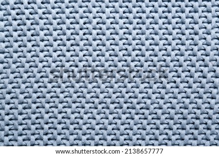 Beautiful light blue knitted fabric as background, top view