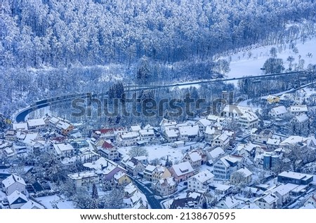 Snowy village of Honau with church in winter from above, municipality of Lichtenstein near Reutlingen, Swabian Alb, Baden-Württemberg, Germany.