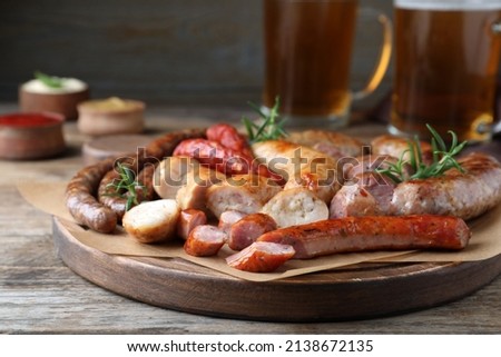 Set of different tasty snacks on wooden table, closeup view