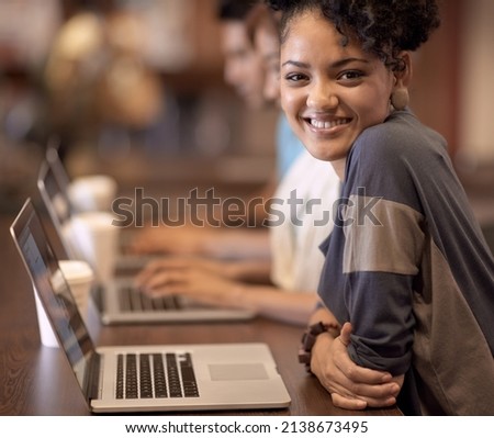 Working towards a bright future. A group of students using a laptop to complete a group assignment. Royalty-Free Stock Photo #2138673495