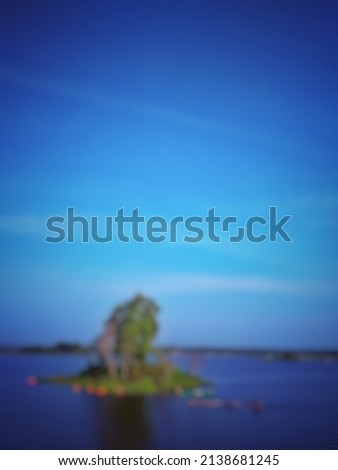  Defocused abstract background of Landscape photo of water dam with tree foregorund. The sky and water looked blue. The weather is very sunny