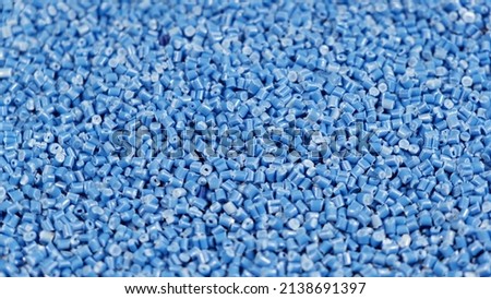 Secondary granule made of polypropylene, Blue Plastic pellets crumbles to the table. Plastic raw materials in granules for industry. Polymer resin. Raw plastic recycling concept Royalty-Free Stock Photo #2138691397