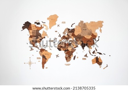 World map of earth showing continents on a wood tree ring textured background on the white wall Royalty-Free Stock Photo #2138705335
