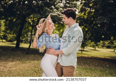 Profile side view portrait of two attractive cheerful couple having fun romance honeymoon on fresh air outdoors. Royalty-Free Stock Photo #2138707037