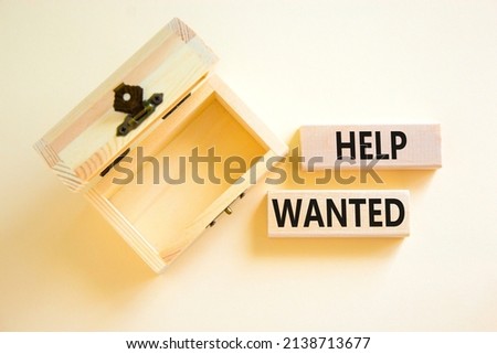 Help wanted and support symbol. Concept words Help wanted on wooden blocks on a beautiful white table white background. Empthy wooden chest. Business support and help wanted concept, copy space.