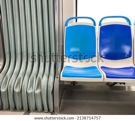 Blue and dark blue passenger chairs in public bus. Vacant subway wagon with free seats. Tram transport seats in empty vehicle